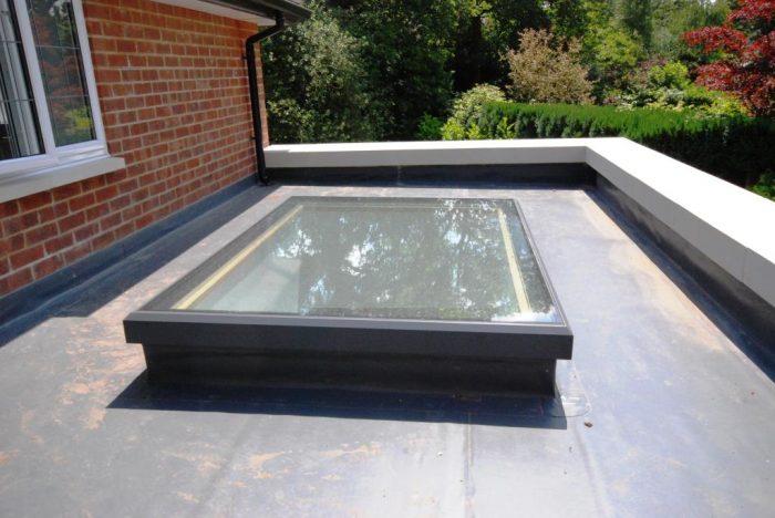 Flat roof lantern on Sarnafil roof with stone coping to parapet