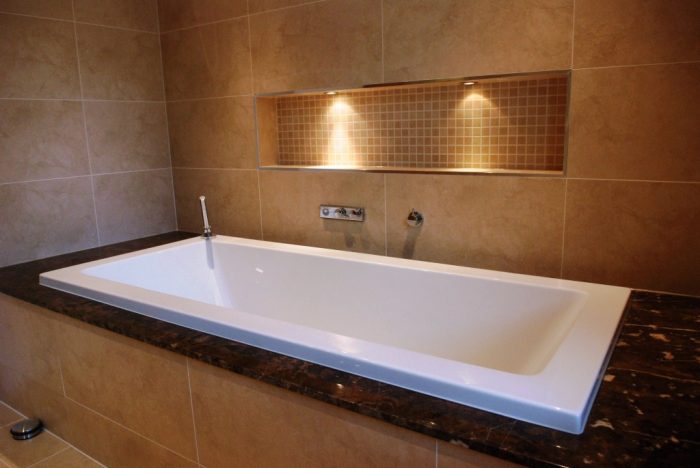 Inset bath with shelf featuring LED lighting