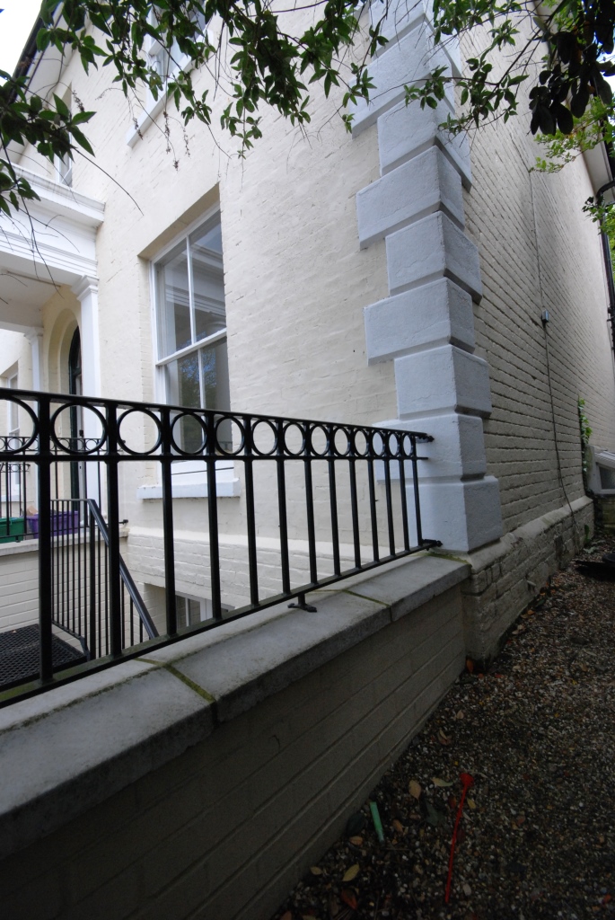 Wrought -iron railings around stairwell to basement conversion below