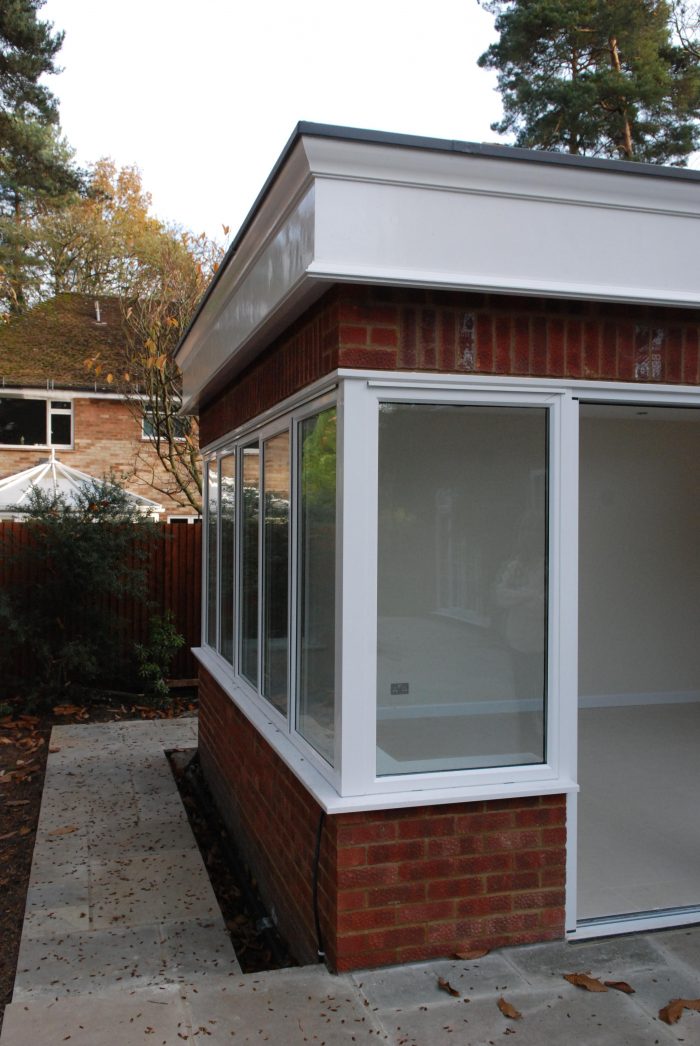 Orangery style extension with minimalist corner post and decorative timber fascia