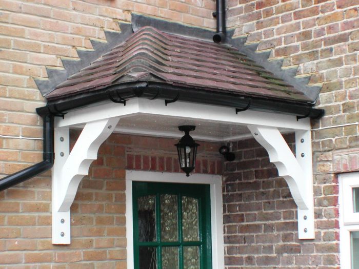 Front porch with hipped tiled roof and decorative gallows brackets