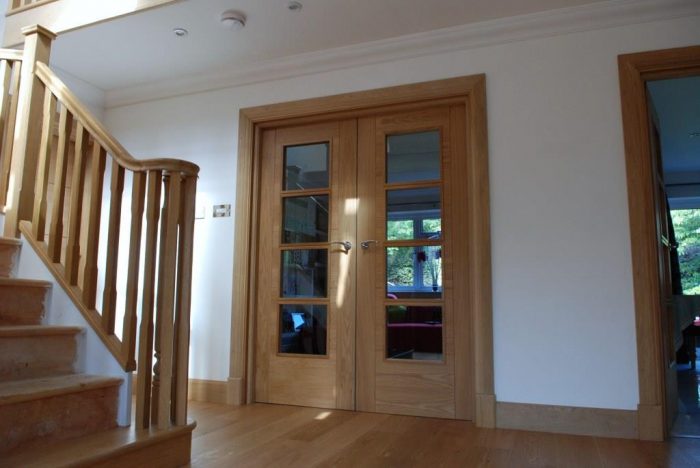 Glazed oak doors off hallway to maximise light