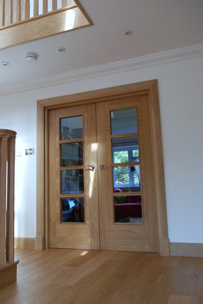 Glazed oak doors off hallway to maximise light