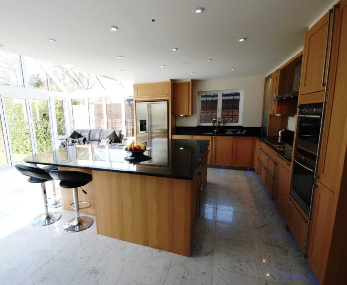 Open plan kitchen/family/dining area linked to patio/garden