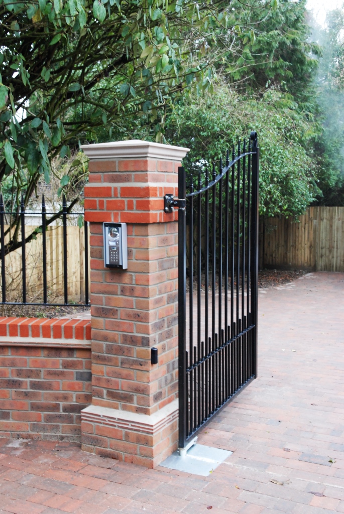 Front wrought-iron gates on decorative brick pillars