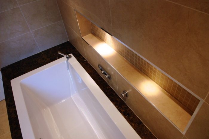 Inset bath with shelf featuring LED lighting