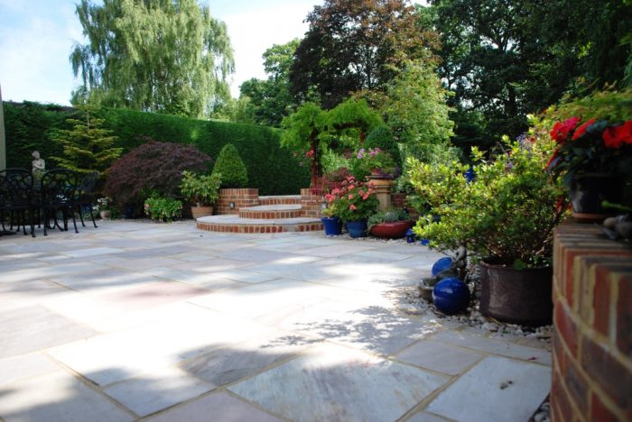 Patio/step arrangement leading to garden beyond 