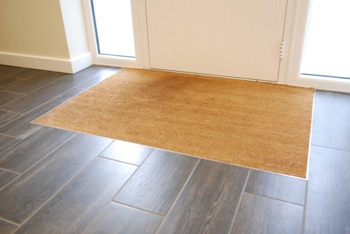 Inset foot mat within flooring system